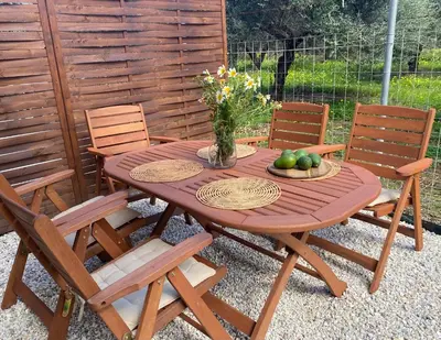 a wooden table with chairs and a vase of fruit at YVONNE's HOUSE in Chania Town