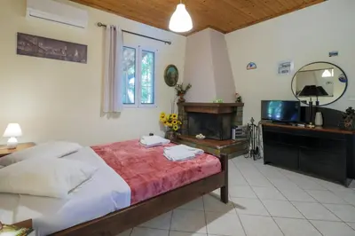 a bedroom with a large bed and a television at Paradise Lost in Gerani Chanion