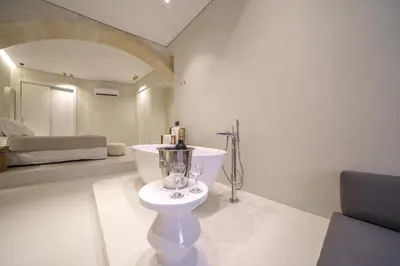 a white bathroom with a toilet and a sink at Amelia Luxury Suites Old Town in Chania Town