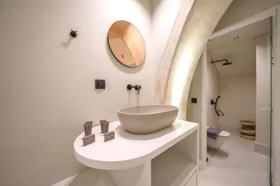 a bathroom with a bowl sink and a mirror at Amelia Luxury Suites Old Town in Chania Town