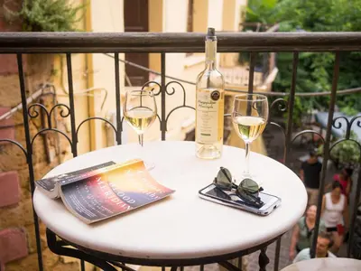 a white table with two glasses and a bottle of wine at Xenon Apartments in Chania Town