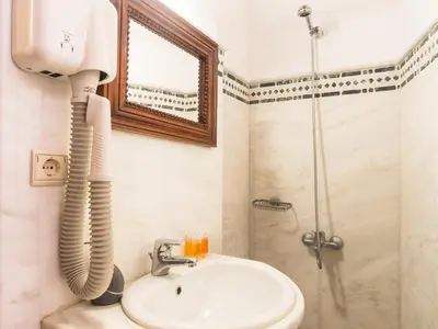 a bathroom with a shower and a sink at Xenon Apartments in Chania Town