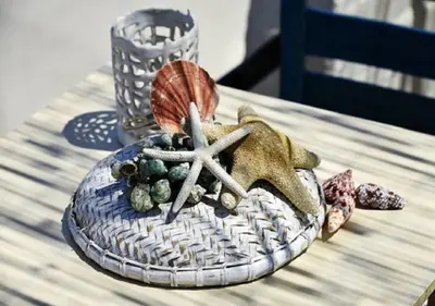 a table with a plate with a shell and a starfish at Andy's Gardens in Gerani Chanion