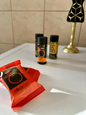 a bathroom counter with two products on a sink at Stratos Apartment in Chania Town