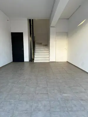 an empty room with a tile floor and stairs at Stratos Apartment in Chania Town