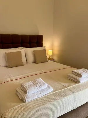 a large bed with two towels on top of it at Stratos Apartment in Chania Town