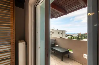 a balcony with a view of the ocean at Alpha delight apartment 3 bedroom in Chania Town