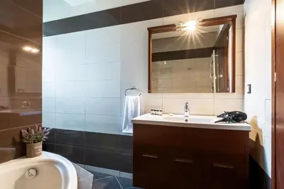 a bathroom with a sink and a mirror at Alpha delight apartment 3 bedroom in Chania Town