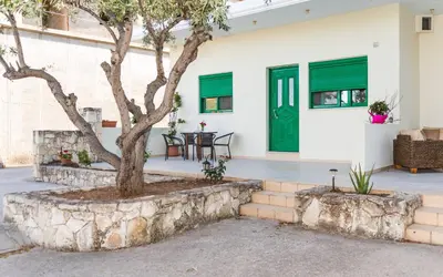 a house with green doors and a tree at Xirouchakis farm2 in Kissamos