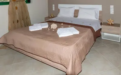 a large bed with towels on it in a room at Xirouchakis farm2 in Kissamos