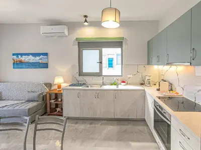 a kitchen with a sink and a window at Newly Built House Steps from the Beach: Everything Within Walking Distance - Enjoy a Car-Free Stay in Agia Marina Nea Kydonias