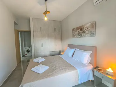 a bedroom with a bed with two towels on it at Newly Built House Steps from the Beach: Everything Within Walking Distance - Enjoy a Car-Free Stay in Agia Marina Nea Kydonias
