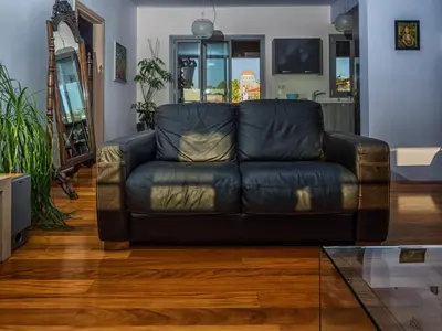 a black leather couch in a living room at Pentari-Bitsakis House in Chania Town