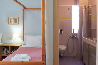 a small bedroom with a bunk bed and a toilet at Pentari-Bitsakis House in Chania Town