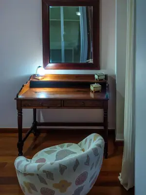a table with a mirror and a chair in a room at Pentari-Bitsakis House in Chania Town