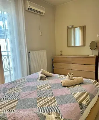 a bedroom with a bed with towels on it at Sea View Apartment #1 in Ayiá
