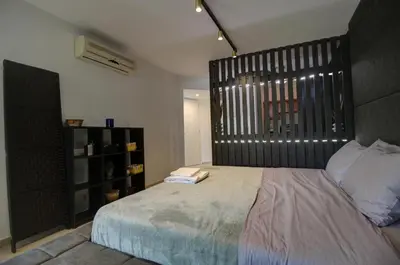 a bedroom with a large bed and a book shelf at Villa Elias & Casseiopia in Chania Town