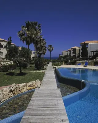 a wooden walkway next to a swimming pool at Villa Elias & Casseiopia in Chania Town