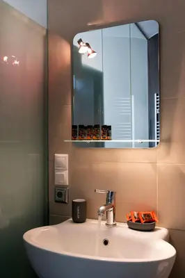 a bathroom with a sink and a mirror at s - plazza residence in Chania Town