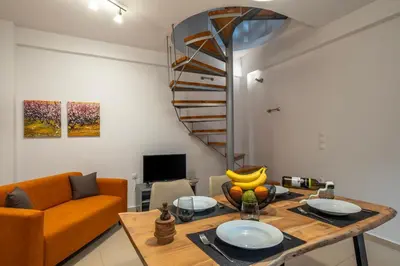 a living room with a table and a couch at s - plazza residence in Chania Town
