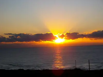 a sunset over the ocean with the sun setting at Villa Katerina with Eco heated pool in Spiliá