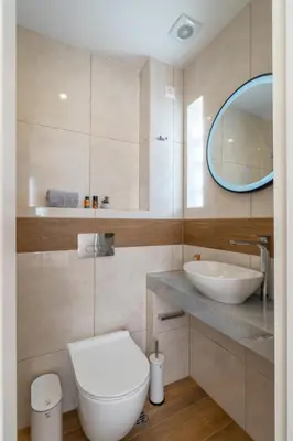 a bathroom with a white toilet and a sink at Odyssey Residences in Chania Town