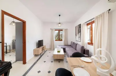 a living room with a couch and a table at Klapas by PosarelliVillas in Chania Town
