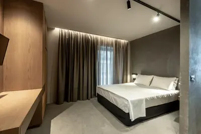 a bedroom with a bed and a large window at Zakro Luxury Living Chania in Chania Town