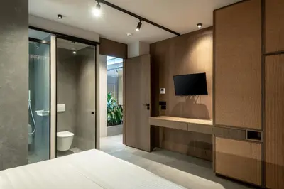 a bedroom with a bed and a tv on a wall at Zakro Luxury Living Chania in Chania Town