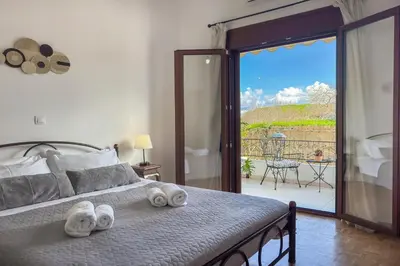 a bedroom with a bed with towels on it at Lion's Yard in Chania Town