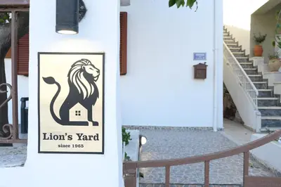 a sign for a lions yard on the side of a door at Lion's Yard in Chania Town
