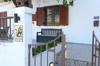 a house with a bench and a window at Lion's Yard in Chania Town