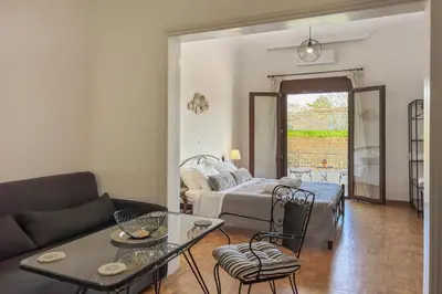 a living room with a couch and a table at Lion's Yard in Chania Town