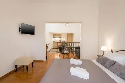 a bedroom with a bed and a living room at Lion's Yard in Chania Town