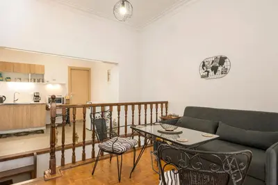a living room with a couch and a table at Lion's Yard in Chania Town