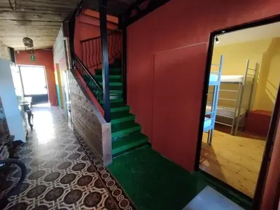 a stairway in a room with a green staircase at Chania Hostel Youth 18-50 in Chania Town