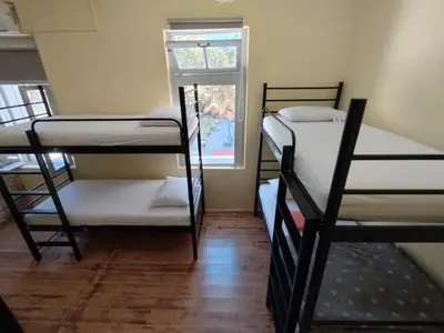 a room with three bunk beds and a window at Chania Hostel Youth 18-50 in Chania Town