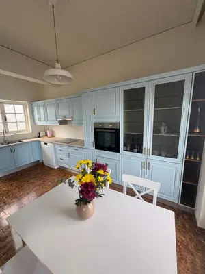 a kitchen with a white table with flowers on it at Linear Flat - City Center - Private Parking in Chania Town