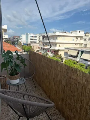 a chair sitting on a balcony with a plant at Linear Flat - City Center - Private Parking in Chania Town
