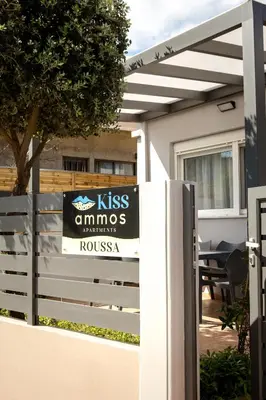 a sign on a fence in front of a house at Kiss-ammos Apartments in Kissamos
