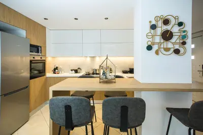 a kitchen with a wooden table and chairs at Kiss-ammos Apartments in Kissamos