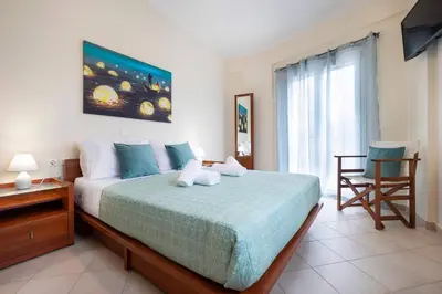 a bedroom with a bed and a desk and a window at Glikanisos House Nipos - ideal for hikers and families 2bd, 6pl, 10min to beach in Nípos