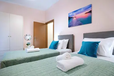 a bedroom with two beds with towels on them at Glikanisos House Nipos - ideal for hikers and families 2bd, 6pl, 10min to beach in Nípos