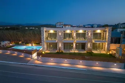 a large building with a swimming pool and lights at Achatis Apartments with sea view in Kolymvari