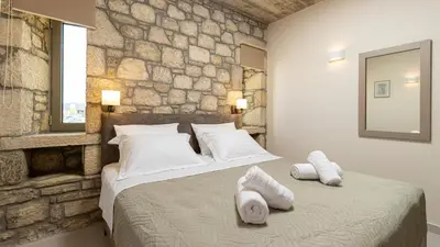 a bedroom with a large bed with towels on it at Achatis Apartments with sea view in Kolymvari