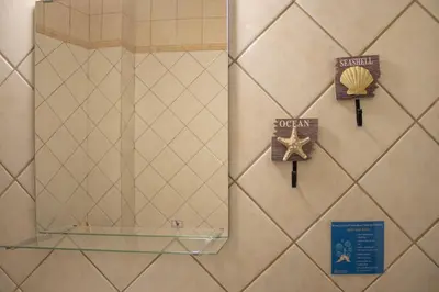 a mirror on a wall with a starfish and a sign at Mamouth Studios in Chania Town