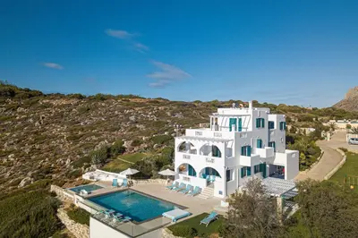 an aerial view of a large white house with a swimming pool at Villa Chryssi in Tersanas
