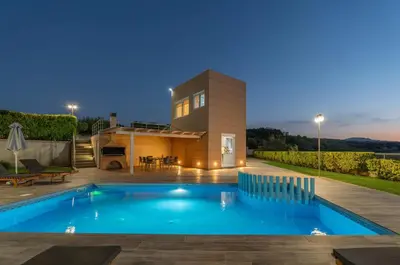 a villa with a swimming pool in front of a house at Villa Ariella With Sea View in Agia Marina Nea Kydonias