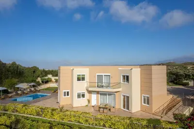 a villa with a swimming pool and a house at Villa Ariella With Sea View in Agia Marina Nea Kydonias