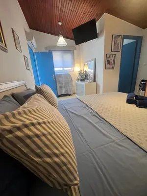 a bedroom with a bed and a tv in a room at Nelly's Private Resindence in Chania Town